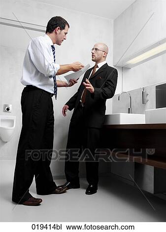 two businessmen having argument in public restroom View Large Photo Image Stock Image - two businessmen having argument in public restroom. Fotosearch