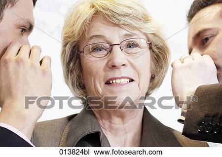 two executive whispering into their boss´s ears View Large Photo Image Stock Image - two executive whispering into their boss´s ears. Fotosearch