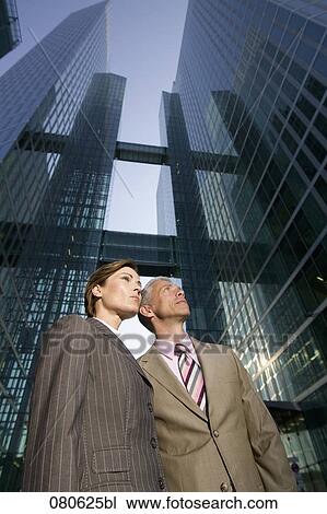 two mature business people in front of office building View Large Photo Image Stock Image - two mature business people in front of office building. Fotosearch