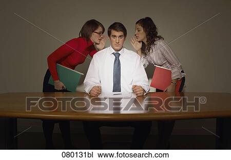 Stock Image - two women whispering into businessman´s ears. Fotosearch