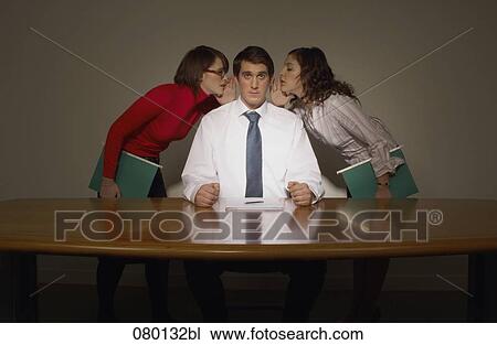 two women whispering into businessman´s ears View Large Photo Image Stock Image - two women whispering into businessman´s ears. Fotosearch