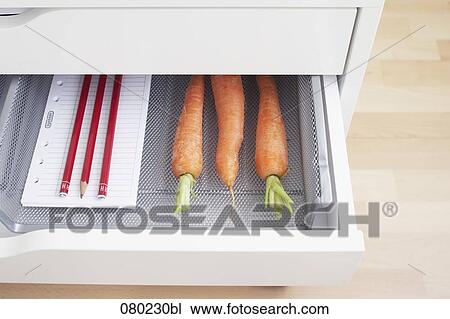 view into open desk drawer containing carrots and pencils View Large Photo Image Stock Image - view into open desk drawer containing carrots and pencils. Fotosearch