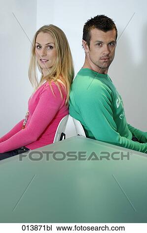 woman and man sitting back to back at table View Large Photo Image Stock Image - woman and man sitting back to back at table. Fotosearch