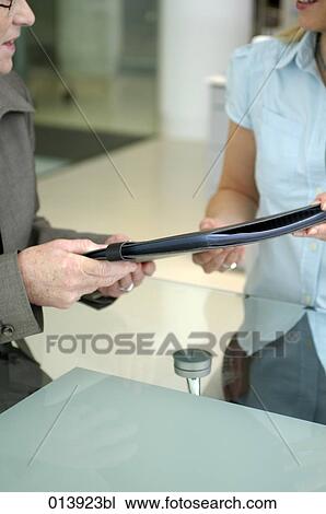 woman handing over file to senior executive View Large Photo Image Stock Image - woman handing over file to senior executive. Fotosearch