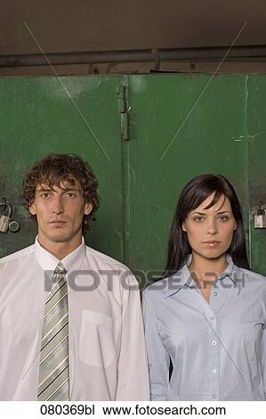 young businessman and businesswoman standing side by side View Large Photo Image Stock Image - young businessman and businesswoman standing side by side. Fotosearch