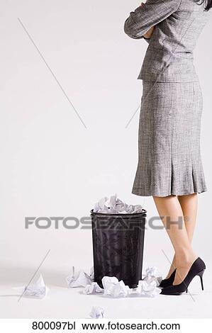 young businesswoman standing in front of wastebasket View Large Photo Image Stock Image - young businesswoman standing in front of wastebasket. Fotosearch