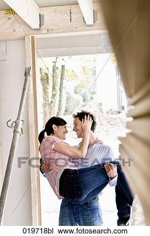 young carrying his wife into new home View Large Photo Image Stock Image - young carrying his wife into new home. Fotosearch