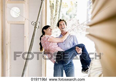young carrying his wife into new home View Large Photo Image Stock Image - young carrying his wife into new home. Fotosearch