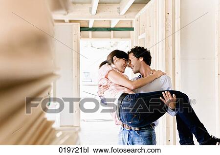 young carrying his wife into new home View Large Photo Image Stock Image - young carrying his wife into new home. Fotosearch