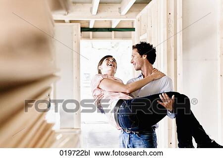 young carrying his wife into new home View Large Photo Image Stock Image - young carrying his wife into new home. Fotosearch