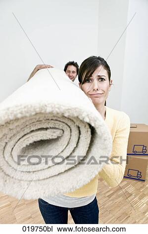young couple carrying carpet into new home View Large Photo Image Stock Image - young couple carrying carpet into new home. Fotosearch