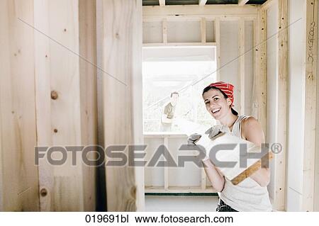 young couple carrying wooden plank on construction site View Large Photo Image Stock Image - young couple carrying wooden plank on construction site. Fotosearch