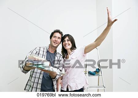 young couple choosing colour for wall in new apartment with colour chart View Large Photo Image Stock Image - young couple choosing colour for wall in new apartment with colour chart. Fotosearch