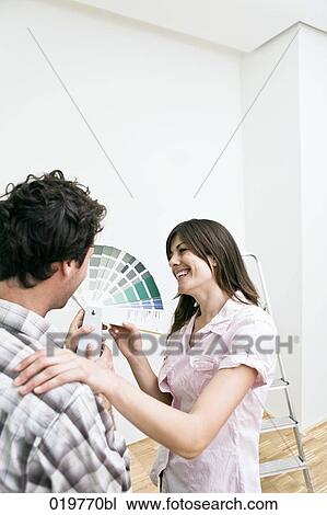 young couple choosing colour for wall in new apartment with colour chart View Large Photo Image Stock Image - young couple choosing colour for wall in new apartment with colour chart. Fotosearch
