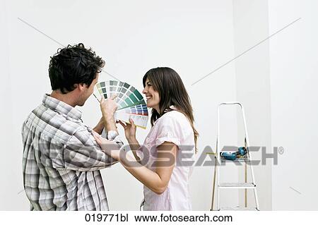 young couple choosing colour for wall in new apartment with colour chart View Large Photo Image Stock Image - young couple choosing colour for wall in new apartment with colour chart. Fotosearch