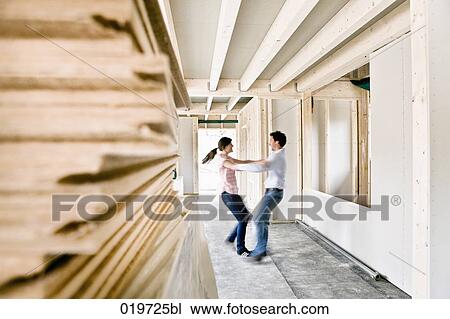 young couple dancing on construction site of their new home View Large Photo Image Stock Image - young couple dancing on construction site of their new home. Fotosearch