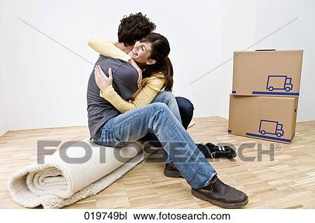 young couple embracing in new home View Large Photo Image Stock Image - young couple embracing in new home. Fotosearch