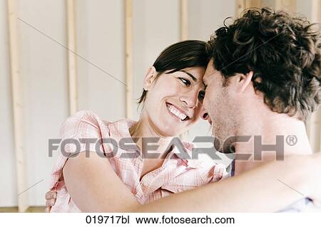 young couple embracing on construction site of their new home View Large Photo Image Stock Image - young couple embracing on construction site of their new home. Fotosearch