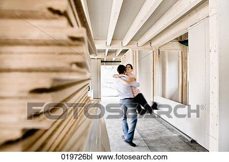 young couple embracing on construction site of their new home View Large Photo Image Stock Image - young couple embracing on construction site of their new home. Fotosearch