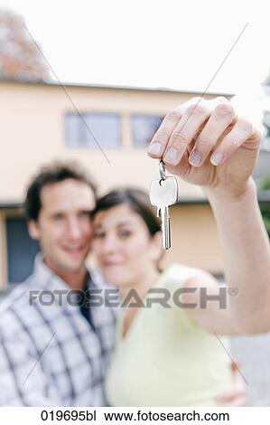 young couple holding the keys to their new home View Large Photo Image Stock Image - young couple holding the keys to their new home. Fotosearch