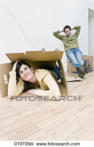 young couple taking break from moving into new home View Large Photo Image Stock Image - young couple taking break from moving into new home. Fotosearch