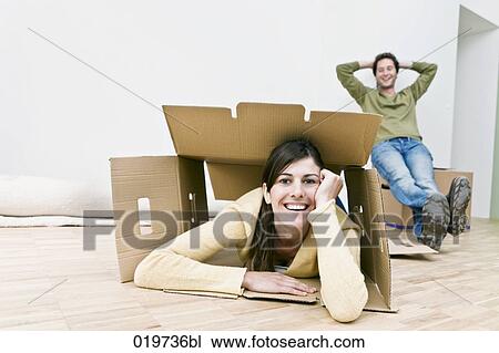 young couple taking break from moving into new home View Large Photo Image Stock Image - young couple taking break from moving into new home. Fotosearch