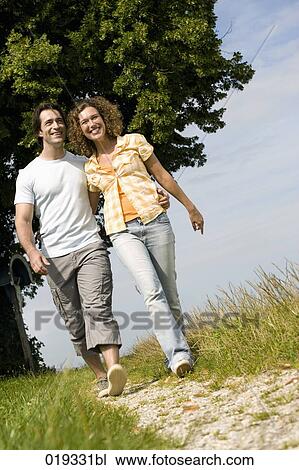 young couple walking in the countryside View Large Photo Image Stock Image - young couple walking in the countryside. Fotosearch