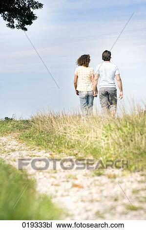 young couple walking in the countryside View Large Photo Image Stock Image - young couple walking in the countryside. Fotosearch