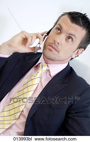 young executive with mobile looking sceptical View Large Photo Image Stock Image - young executive with mobile looking sceptical. Fotosearch