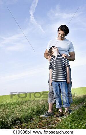 young father and his looking at each other View Large Photo Image Stock Image - young father and his looking at each other. Fotosearch