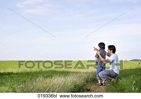 young father and his son in the countryside father giving explanation View Large Photo Image Stock Image - young father and his son in the countryside father giving explanation. Fotosearch
