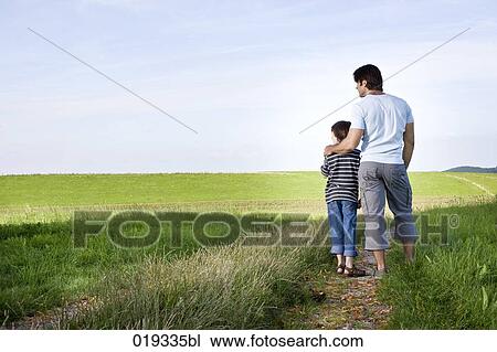 young father and his son looking the horizon in the countryside View Large Photo Image Stock Image - young father and his son looking the horizon in the countryside. Fotosearch