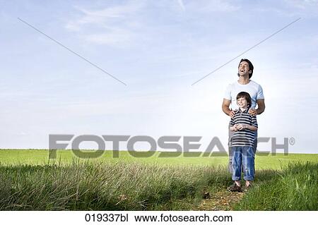 young father and his son standing on path in the countryside View Large Photo Image Stock Image - young father and his son standing on path in the countryside. Fotosearch