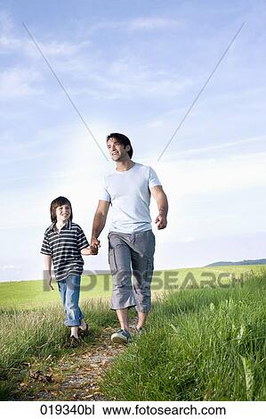 young father and his son walking on path in the countryside View Large Photo Image Stock Image - young father and his son walking on path in the countryside. Fotosearch