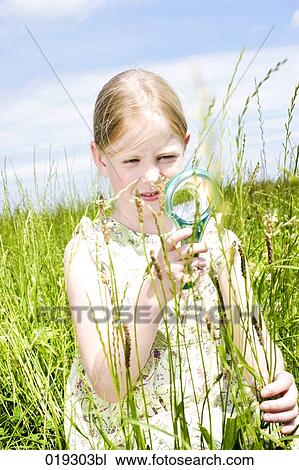 young girl looking at grass through magnifying glass View Large Photo Image Stock Image - young girl looking at grass through magnifying glass. Fotosearch