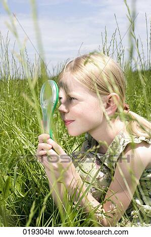 young girl looking at grass through magnifying glass View Large Photo Image Stock Image - young girl looking at grass through magnifying glass. Fotosearch