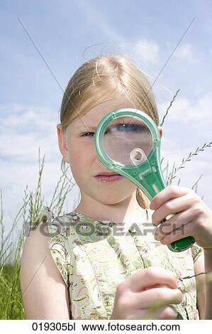young girl looking at grass through magnifying glass View Large Photo Image Stock Image - young girl looking at grass through magnifying glass. Fotosearch