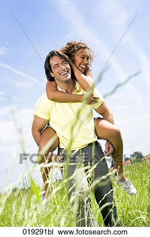 young man giving wman piggyback ride View Large Photo Image Stock Image - young man giving wman piggyback ride. Fotosearch