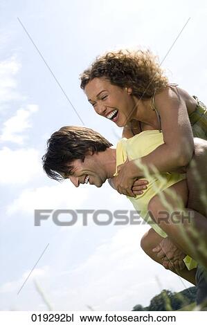 young man giving wman piggyback ride View Large Photo Image Stock Image - young man giving wman piggyback ride. Fotosearch