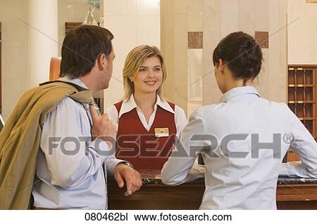 young receptionist talking to hotel guests View Large Photo Image Stock Image - young receptionist talking to hotel guests. Fotosearch