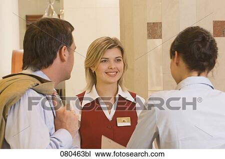 young receptionist talking to hotel guests View Large Photo Image Stock Image - young receptionist talking to hotel guests. Fotosearch