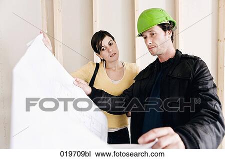 young woman and architect looking at building plan View Large Photo Image Stock Image - young woman and architect looking at building plan. Fotosearch