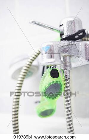 Stock Image - close-up of bathtub with fittings and swimming goggles. Fotosearch