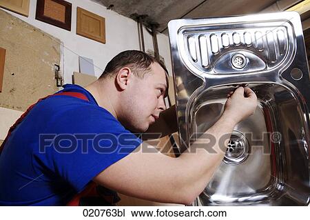 craftsman assembling kitchen sink View Large Photo Image Stock Image - craftsman assembling kitchen sink. Fotosearch