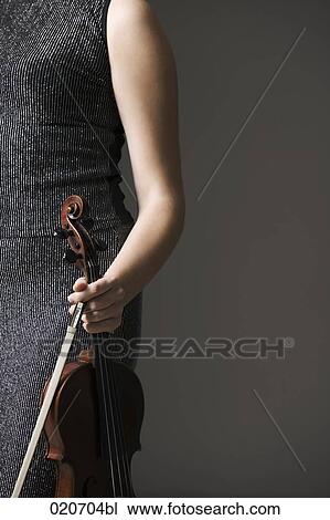 detail of female violinst holding instrument and bow View Large Photo Image Stock Image - detail of female violinst holding instrument and bow. Fotosearch