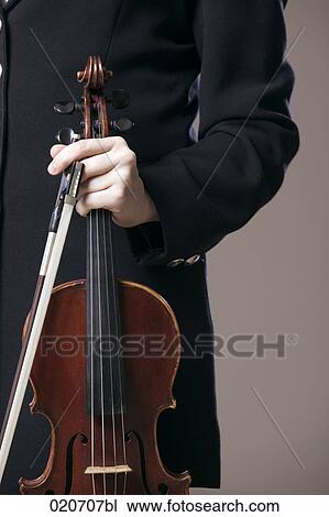 detail of female violinst holding instrument and bow View Large Photo Image Stock Image - detail of female violinst holding instrument and bow. Fotosearch