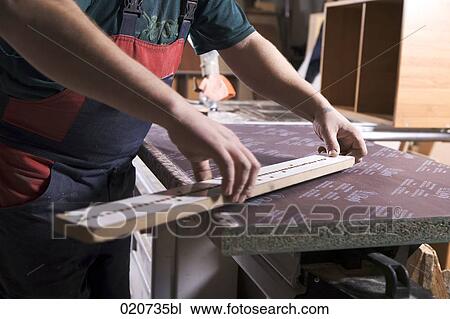 detail of worker in furniture workshop measuring batten View Large Photo Image Stock Image - detail of worker in furniture workshop measuring batten. Fotosearch