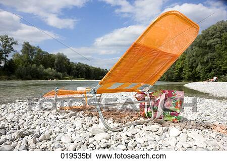 empty orange sunlounger on riverbank View Large Photo Image Stock Image - empty orange sunlounger on riverbank. Fotosearch