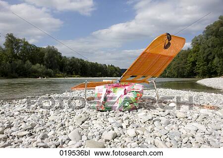 empty orange sunlounger on riverbank View Large Photo Image Stock Image - empty orange sunlounger on riverbank. Fotosearch