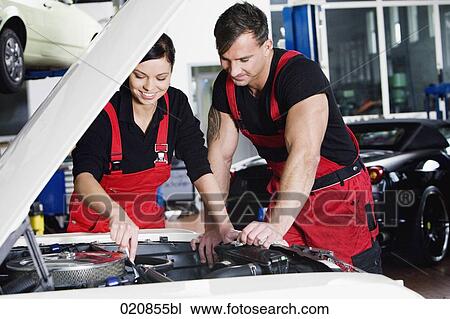 female and male mechanic repairing car engine View Large Photo Image Stock Image - female and male mechanic repairing car engine. Fotosearch